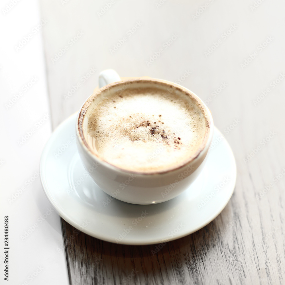 cappuccino Cup with foam on a wooden table in a cafe cappuccino Cup with foam on a wooden table in a cafe