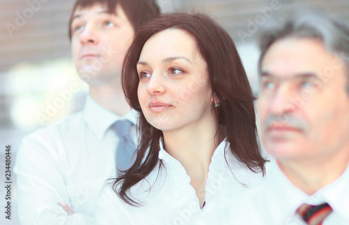 Successful business group in a row smiling and looking up