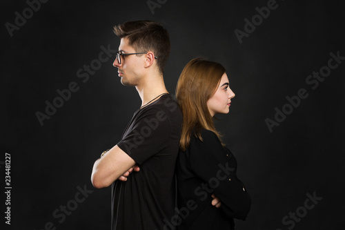 Couple back to back not talking after an argument on black screen