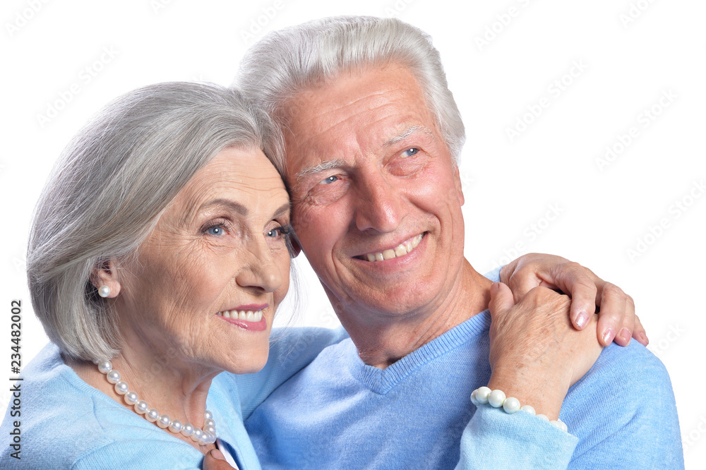 Happy senior couple posing isolated on white background