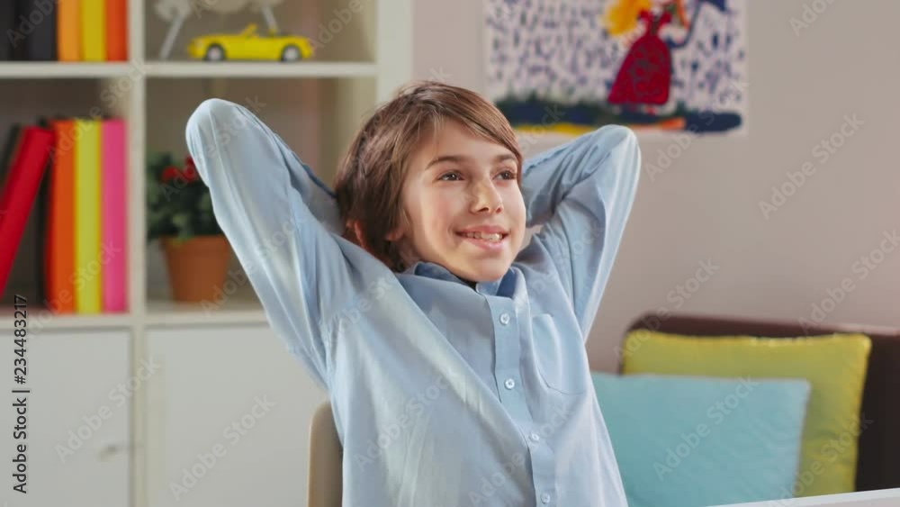 Schoolboy turning off his laptop computer Schoolboy turning off his laptop computer