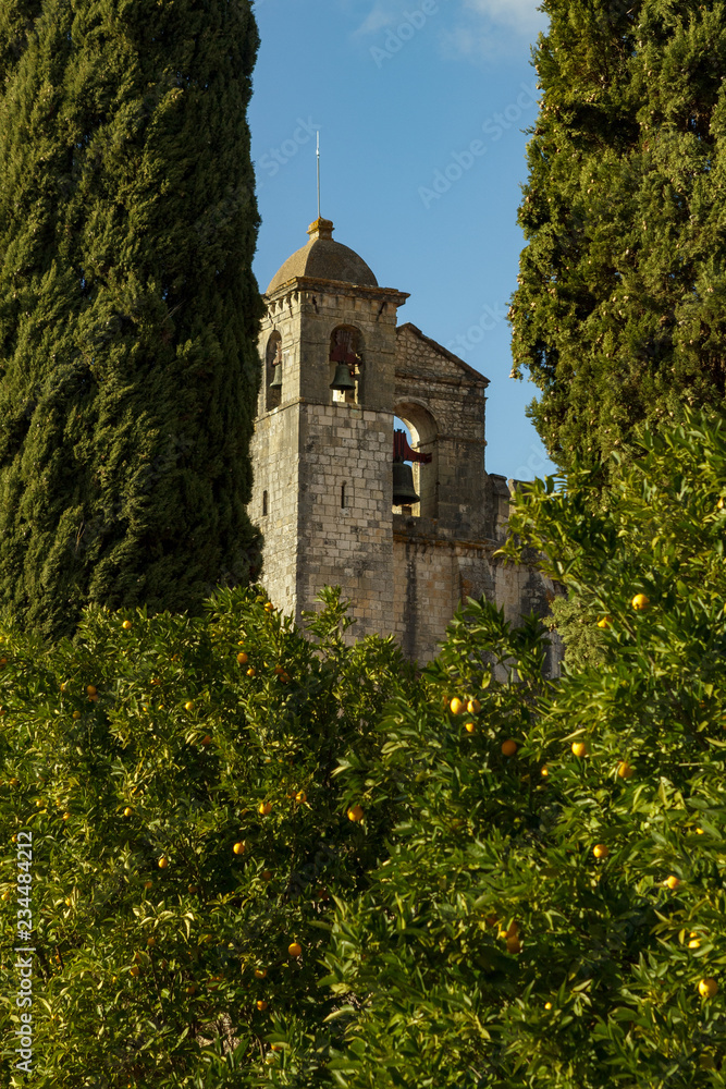 Medieval church belfry seen between hedges in Portugal