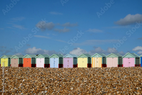 Tableau sur toile A row of ten colourful Beach huts on Brighton beach the pebble beach in the fore