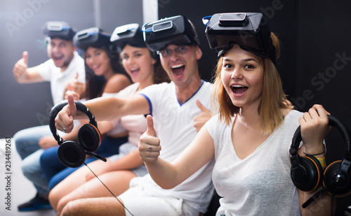  people using virtual reality glasses delighted with videogames and new tech