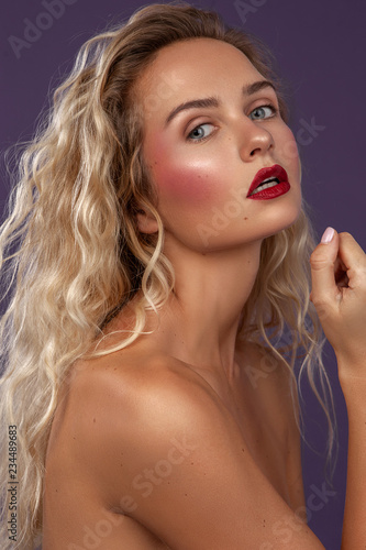 beauty portrait of a female with long wavy blonde hair with makeup