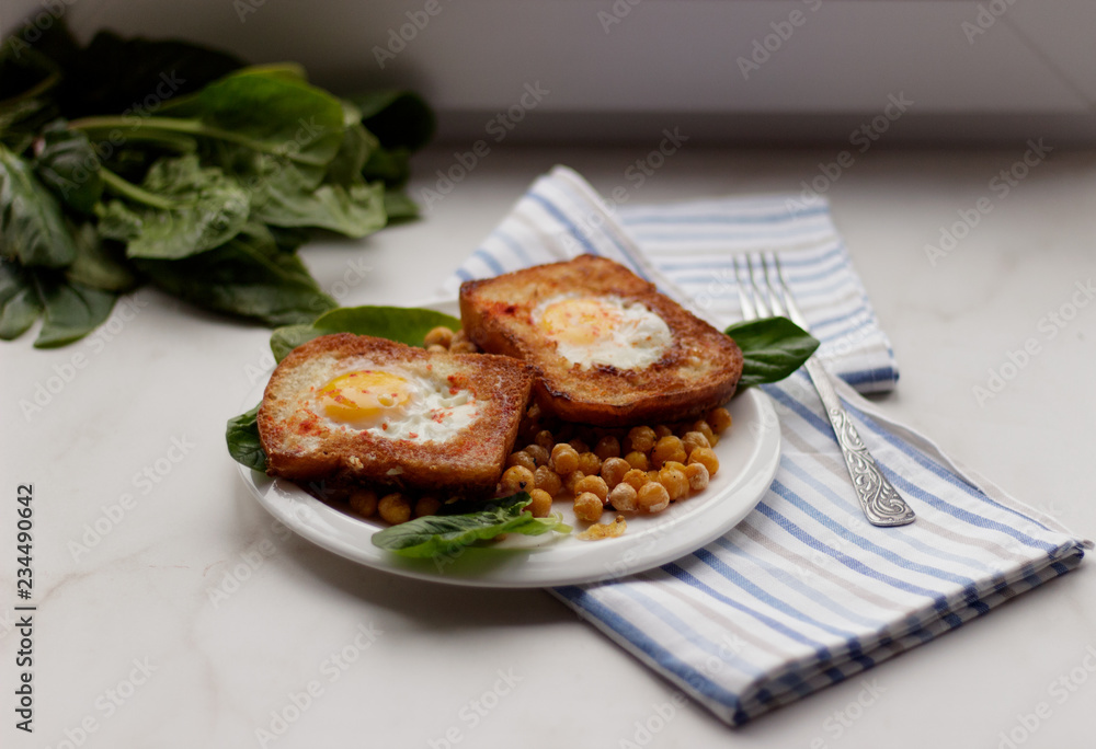 Toast with egg in white plate on white marble background. Healthy breakfast Toast with egg in white plate on white marble background. Healthy breakfast