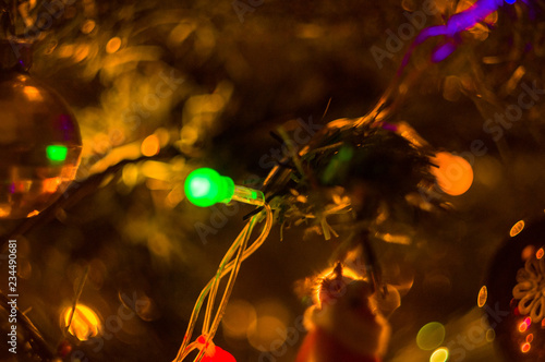 Christmas background-garlands with colorful lights on a decorated Christmas tree, bokeh