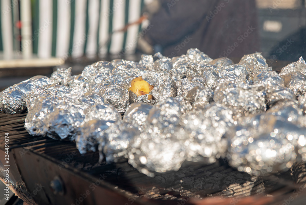 Small potatoes in foil on the grill