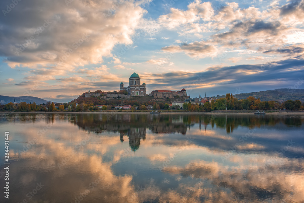 Amazing sunrise view over Danube river, beautiful reflections of morning clouds mirrored in water, Esztergom, Hungary
