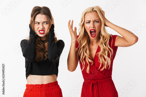 Portrait of two angry young smartly dressed women