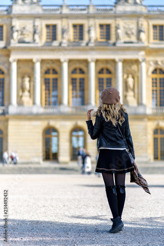 Woman at Versailles Palace. Young french dressed tourist girl admiring the views. Portrait soft bokeh background © castecodesign