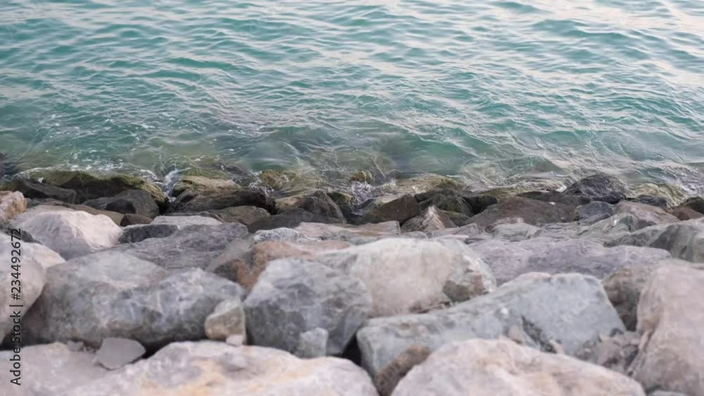 Small waves near a stone bank Small waves near a stone bank