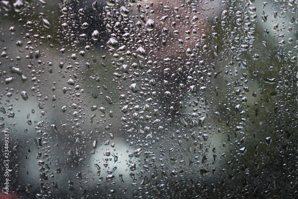 water drops on the glass while it's raining 