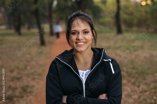 Portrait of beautiful woman preparing to exercise in park