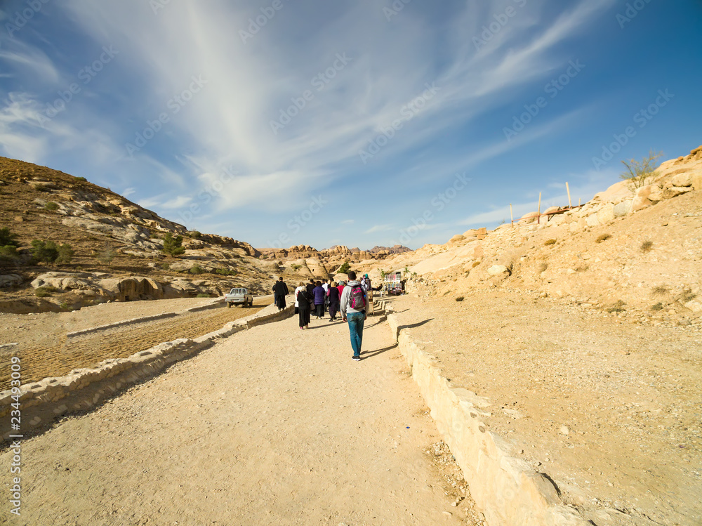 Petra, Jordan - circa Jan, 2018: Tourists walking to the Treasury, Petra, Jordan