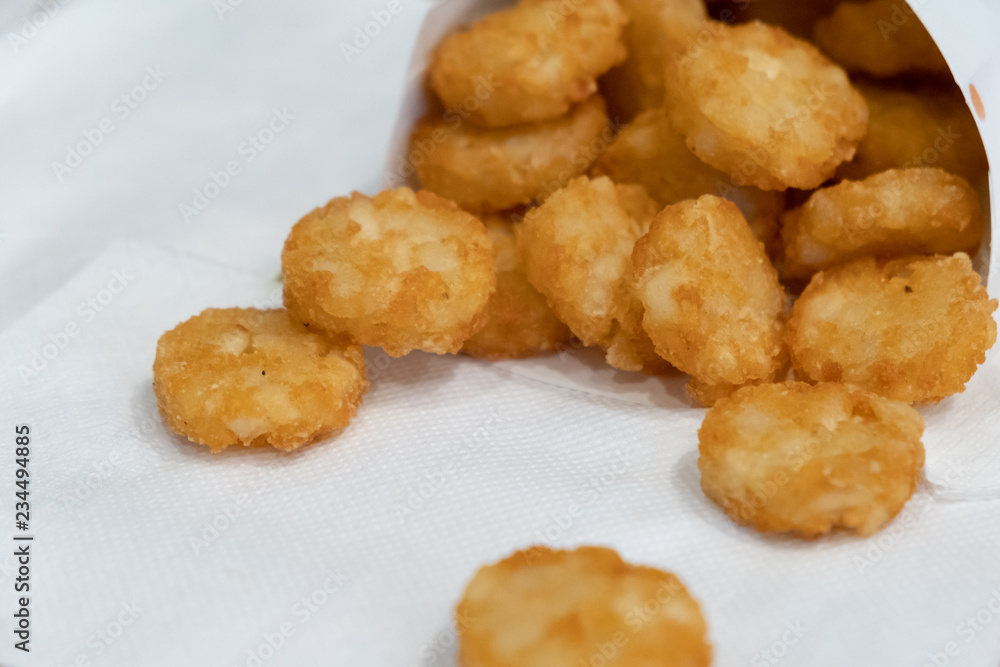 Crispy Hash Browns, American Breakfast Deep Fried Processed Food Frozen Easy To Eat, fried potato pancakes with dill on paper background Crispy Hash Browns, American Breakfast Deep Fried Processed Food Frozen Easy To Eat, fried potato pancakes with dill on paper background