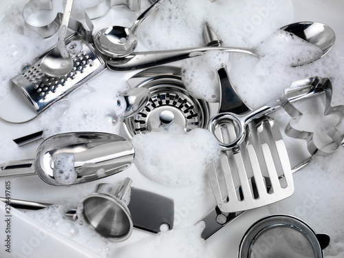 WASHING KITCHEN UTENSILS IN SINK