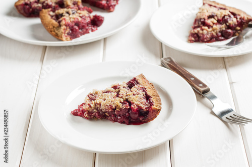Slice of delicious homemade sour cherry pie on plate