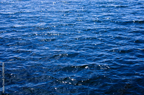 The brilliant blue water of the Baltic Sea glistens in the sun a few days after midsummer, near the Island of Nicklösa in the Åland Islands, Finland.