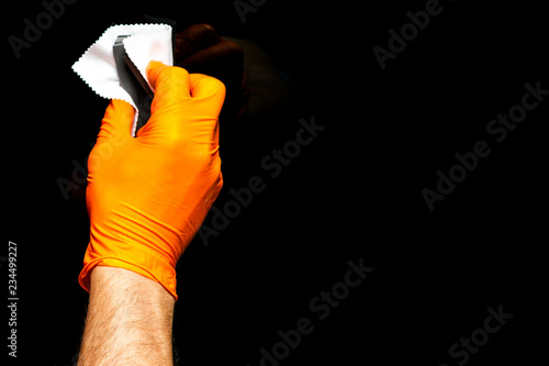 Car polish wax worker hands polishing car. Buffing and polishing vehicle. Car detailing. Man holds a polisher in the hand and polishes the car. Tools for polishing