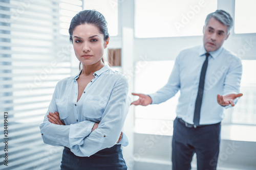 Filthy coworker. Confused superior expressively asking his employee about situation and her discontent photo