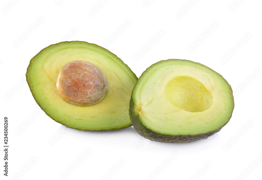 half cut ripe avocados with seed on white background