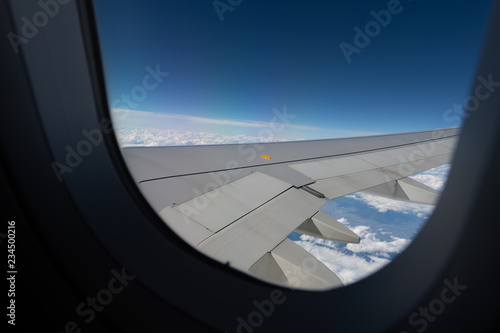 Airplane wing view from window beautiful sky.