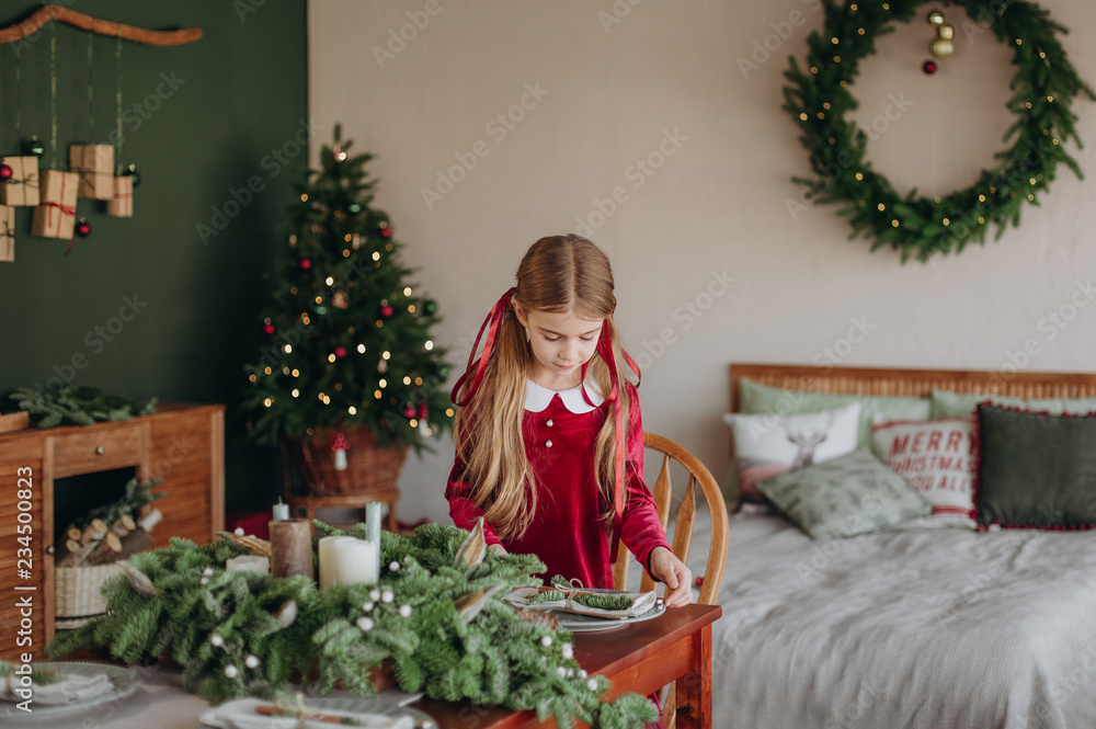 girl burgundy dress decorates Christmas rustic room girl burgundy dress decorates Christmas rustic room