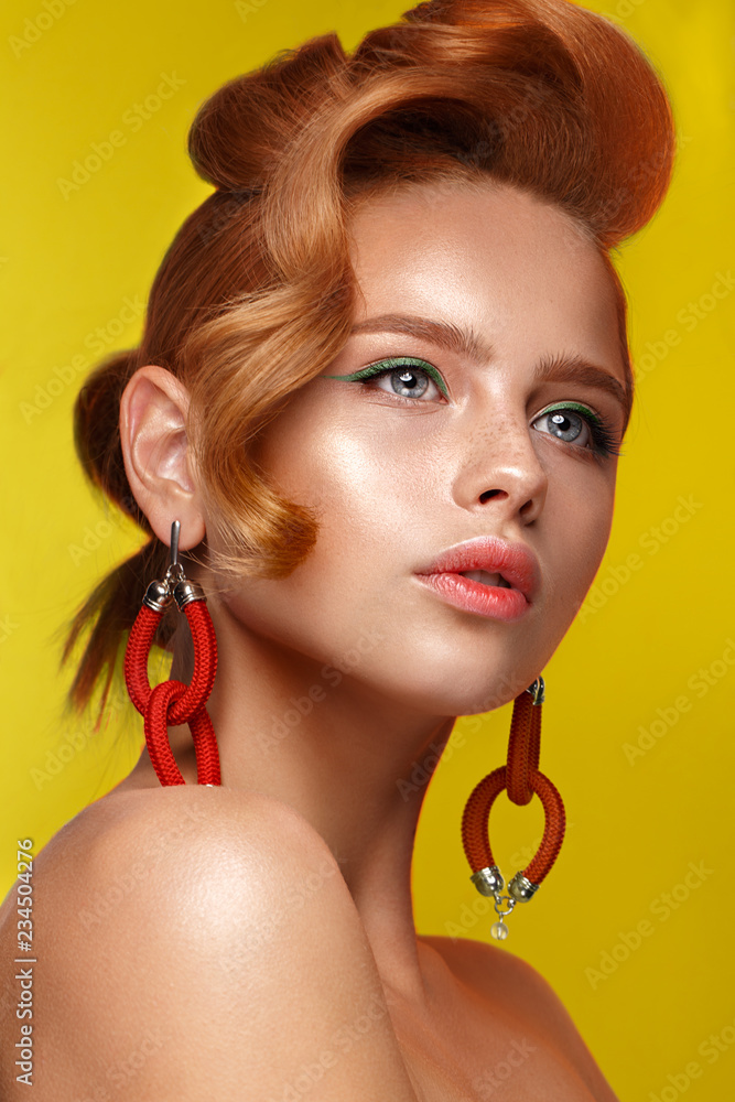 Beautiful girl with unusual accessories and make-up on a bright background. Beauty face.