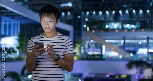 Canvas Print Man use of mobile phone in city