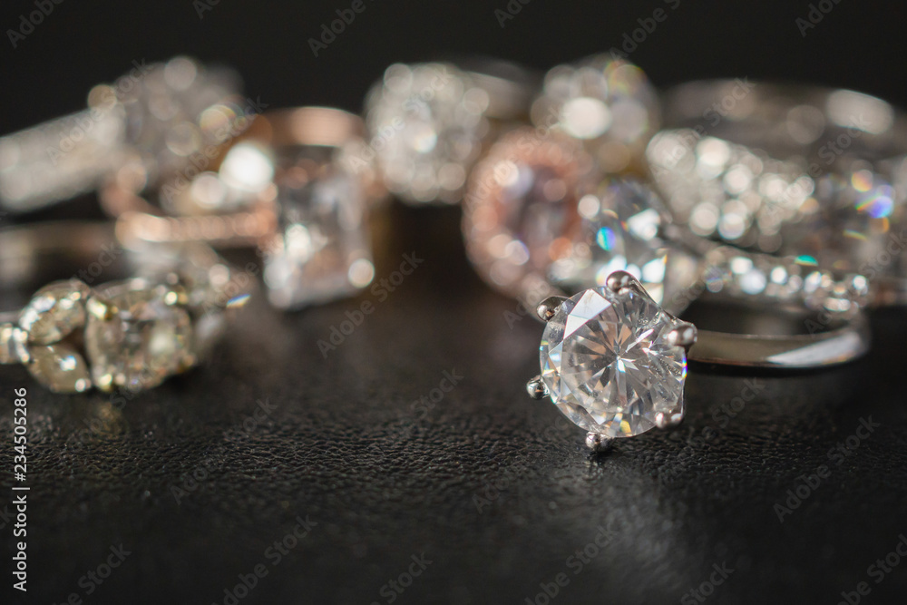 Jewelry diamond rings set on black background close up Jewelry diamond rings set on black background close up