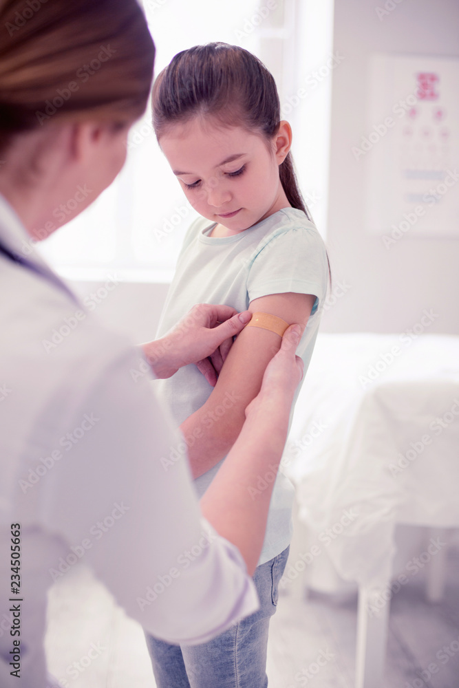 Cut hand. Dark-haired cute little preschool girl visiting doctor in the hospital after cutting her hand Cut hand. Dark-haired cute little preschool girl visiting doctor in the hospital after cutting her hand