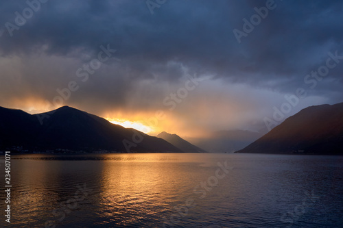 sunset through the mountains and clouds