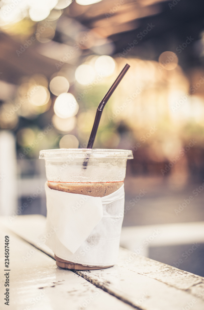 Cold beverage glass or cappuccino ice coffee on white wooden table at coffee shop Cold beverage glass or cappuccino ice coffee on white wooden table at coffee shop