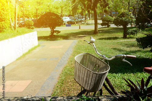 the bicycle parked on front yard of buildings with orange light in the morning