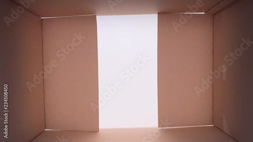 Simple brown carton box - opening cardboard box POV of in box. Unboxing gift - concept of holidays or shipping. 