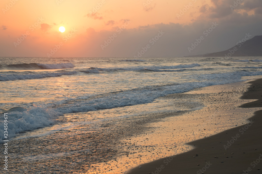 Sunrise at sea. Sunny path and waves. Georgioupolis beach, Crete Greece