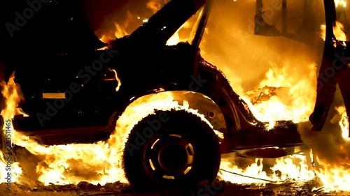 Burning car body, burning iron, broken car on fire photo