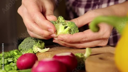 woman selects broccoli for vegetable salad making, healthy food concept