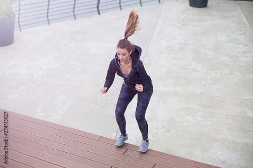 Fitness woman jumping outdoor in urban enviroment © BGStock72