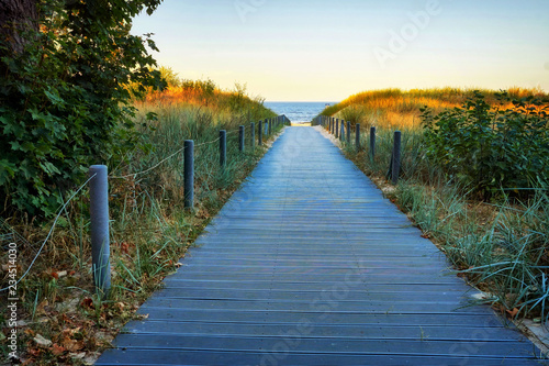 Wooden path to the Baltic sea beach through the sand dunes with sea view. Ahlbeck  Germany