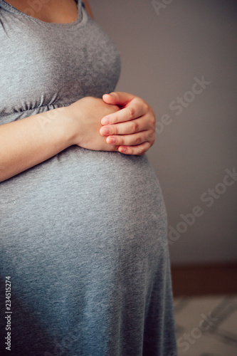 A pregnant woman's hands on belly
