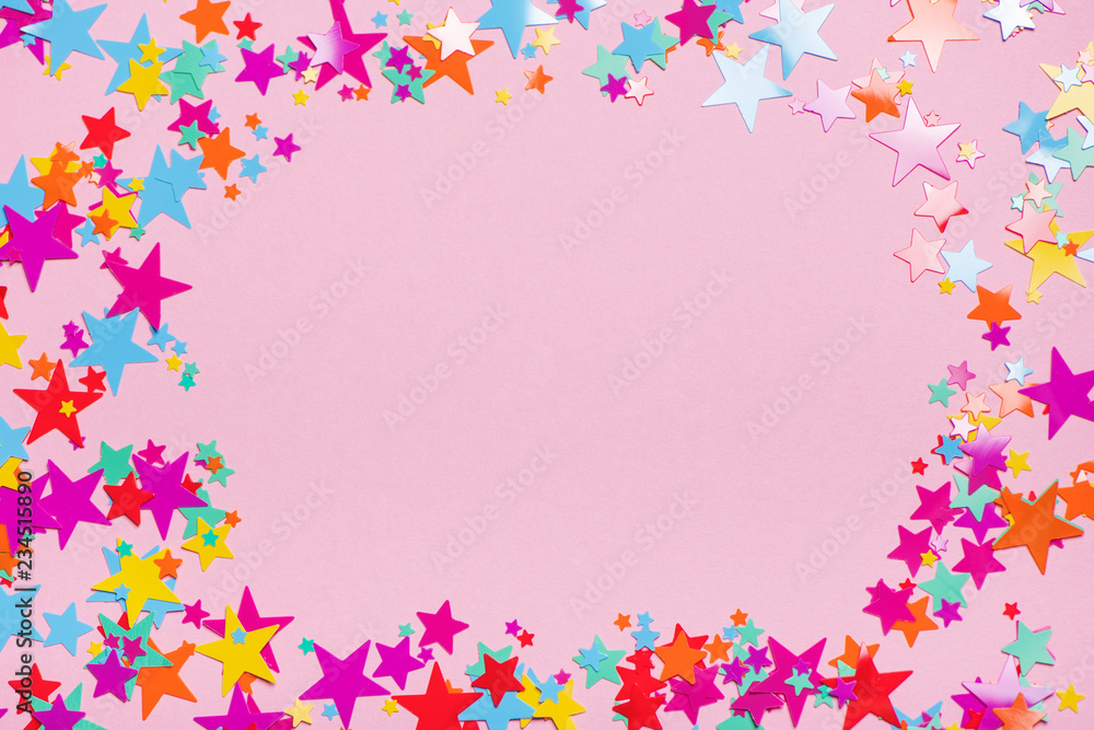 Colorful confetti on pink background with horizontal copy space at center