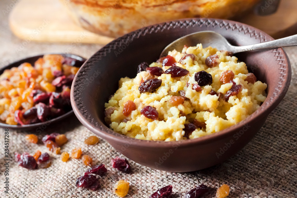 Sweet millet porridge with raisins and dried cranberries Sweet millet porridge with raisins and dried cranberries