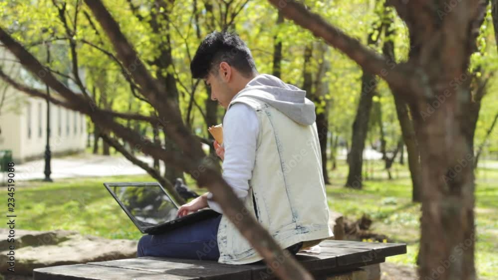 Man freelancer eating ice-cream and working Man freelancer eating ice-cream and working