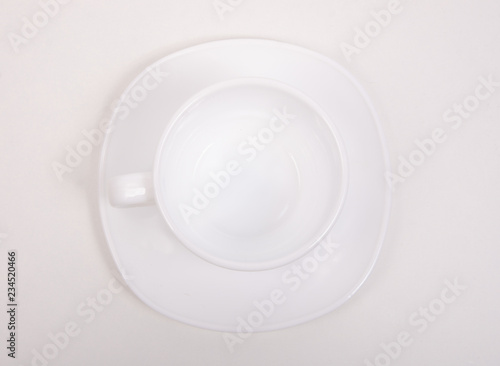 White saucer cup on white background isolation, top view