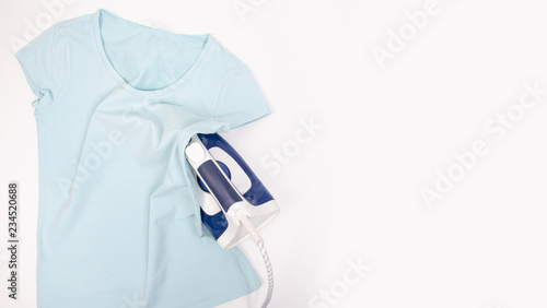 Blue iron blue shirt on ironing board top view, household. Isolation white background