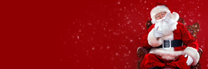 santa is sitting in armchair