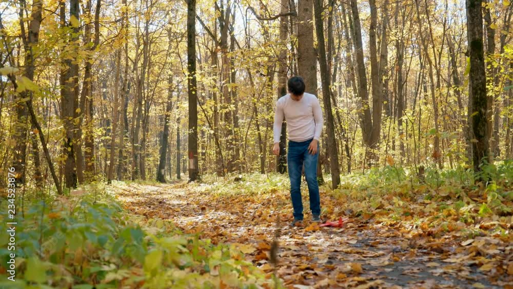 A young man in an autumn park launches a toy plane. 4k A young man in an autumn park launches a toy plane. 4k