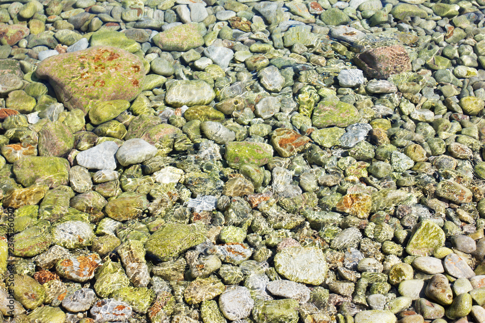 Pebble stones under clear water in the sea Pebble stones under clear water in the sea
